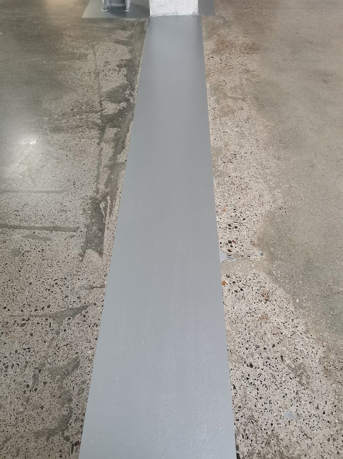 After: Worn traffic aisle with markings: before and after treatment