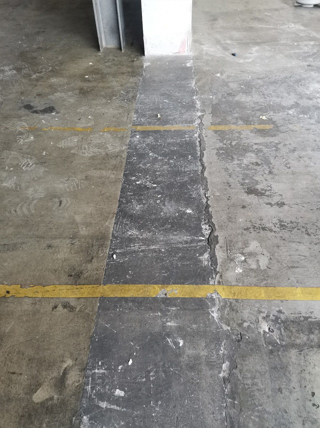 Before: Worn traffic aisle with markings: before and after treatment